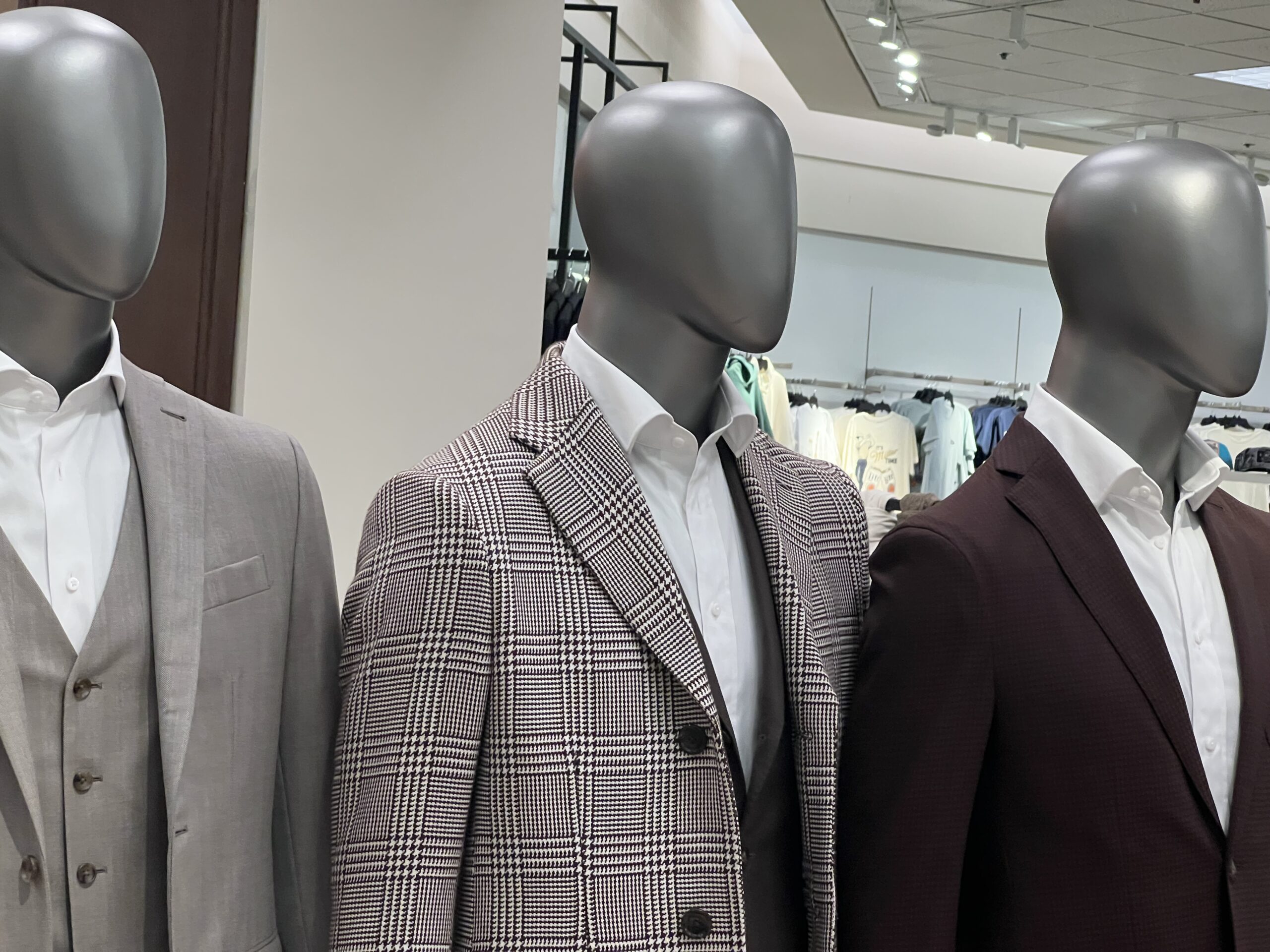 Tailor working inside the shop with sewing tools and fabrics