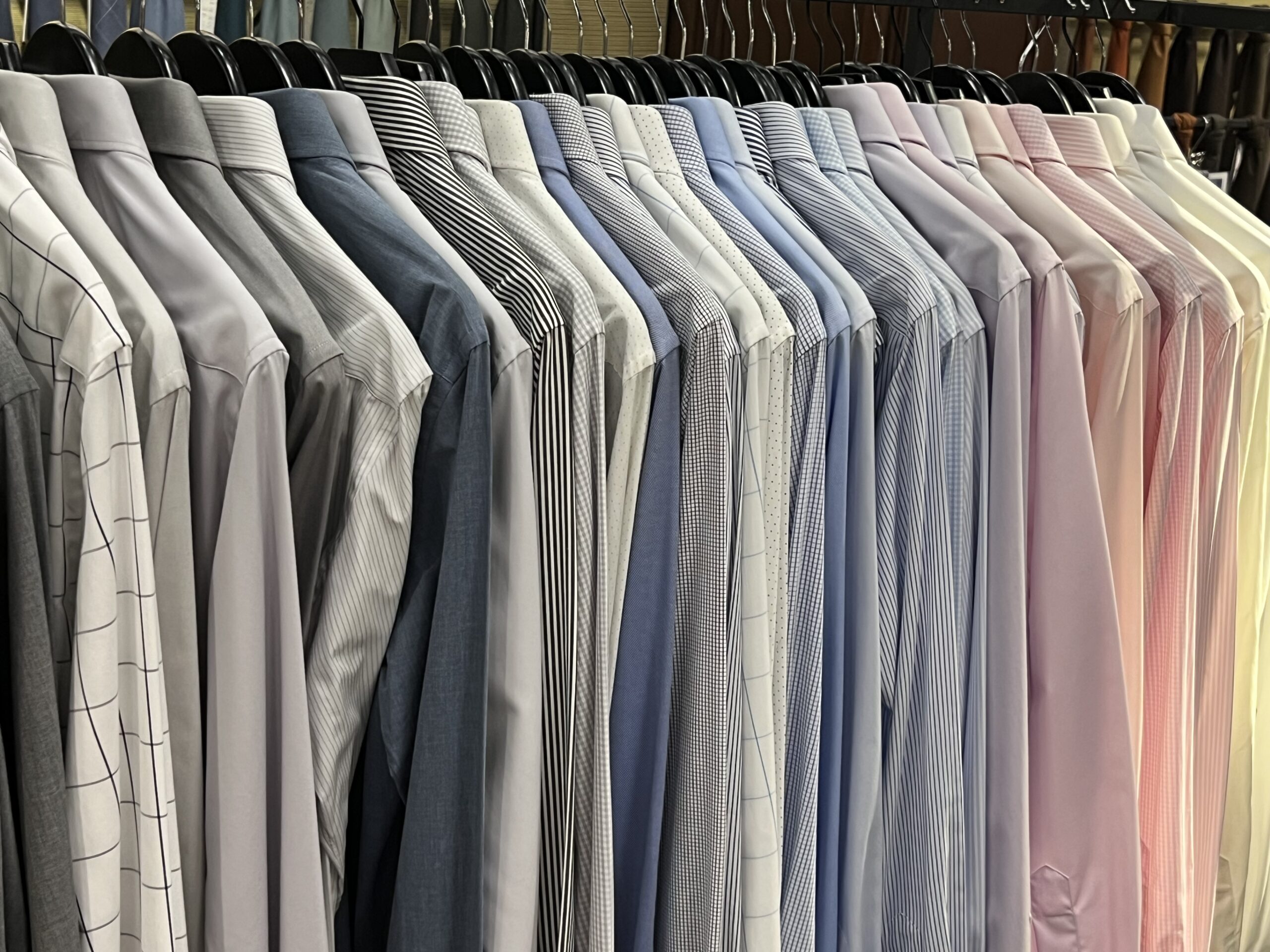 Tailor adjusting men’s suit inside the workshop